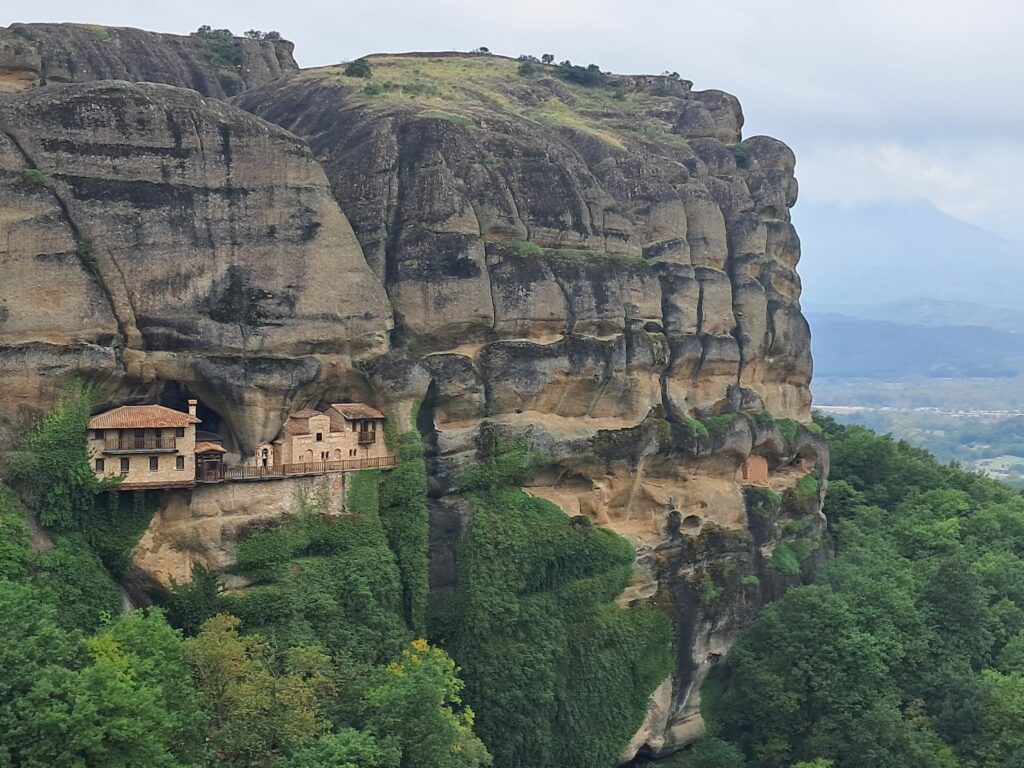 Hermit cave monastery built into the rock face at Meteora, visible from the guided hiking trail near Kalambaka