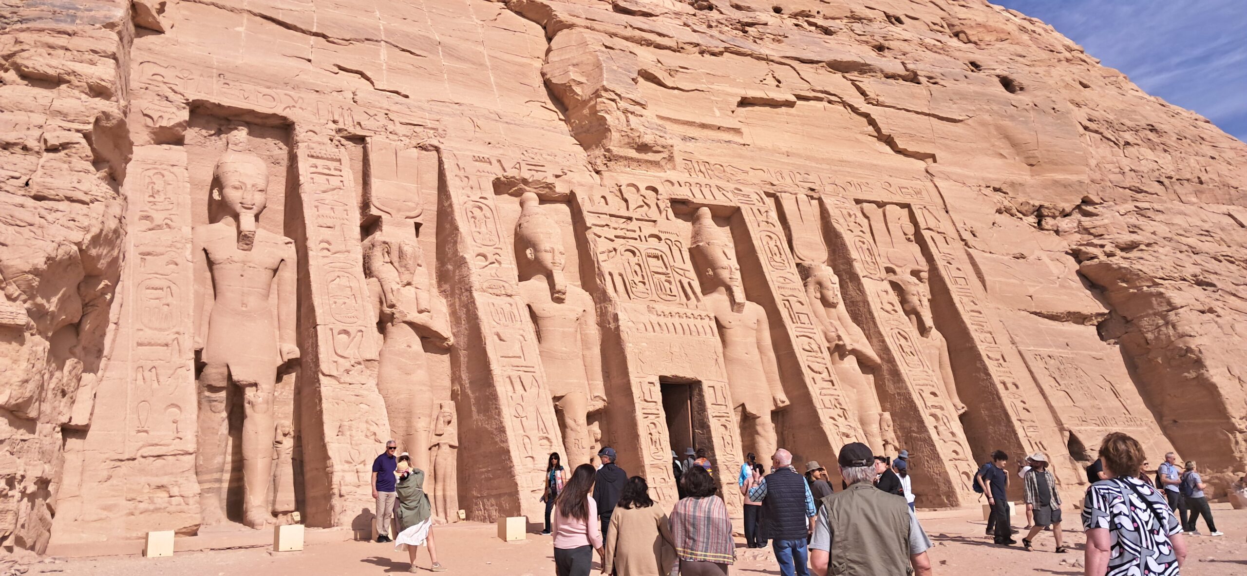 The colossal statues of Abu Simbel with morning crowds
