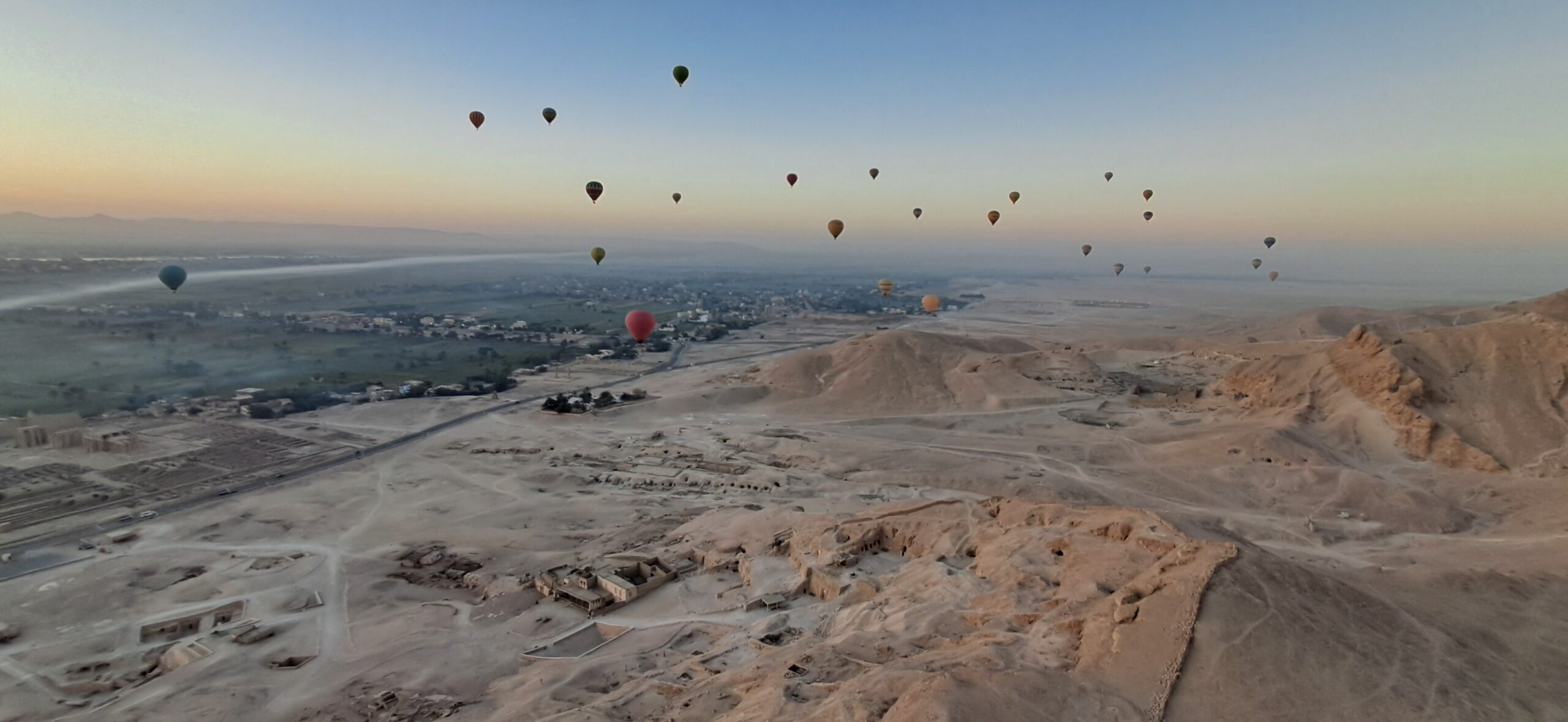 Hot air balloons rising over Luxor at dawn