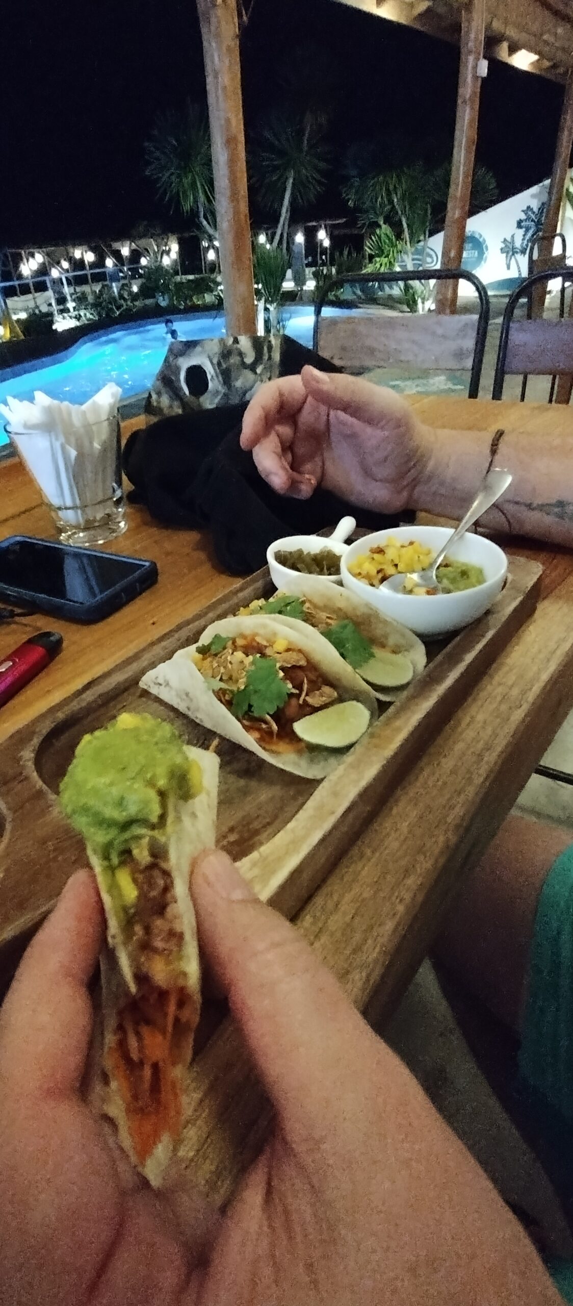 Holding a vegan taco at Seaesta Komodo in the evening