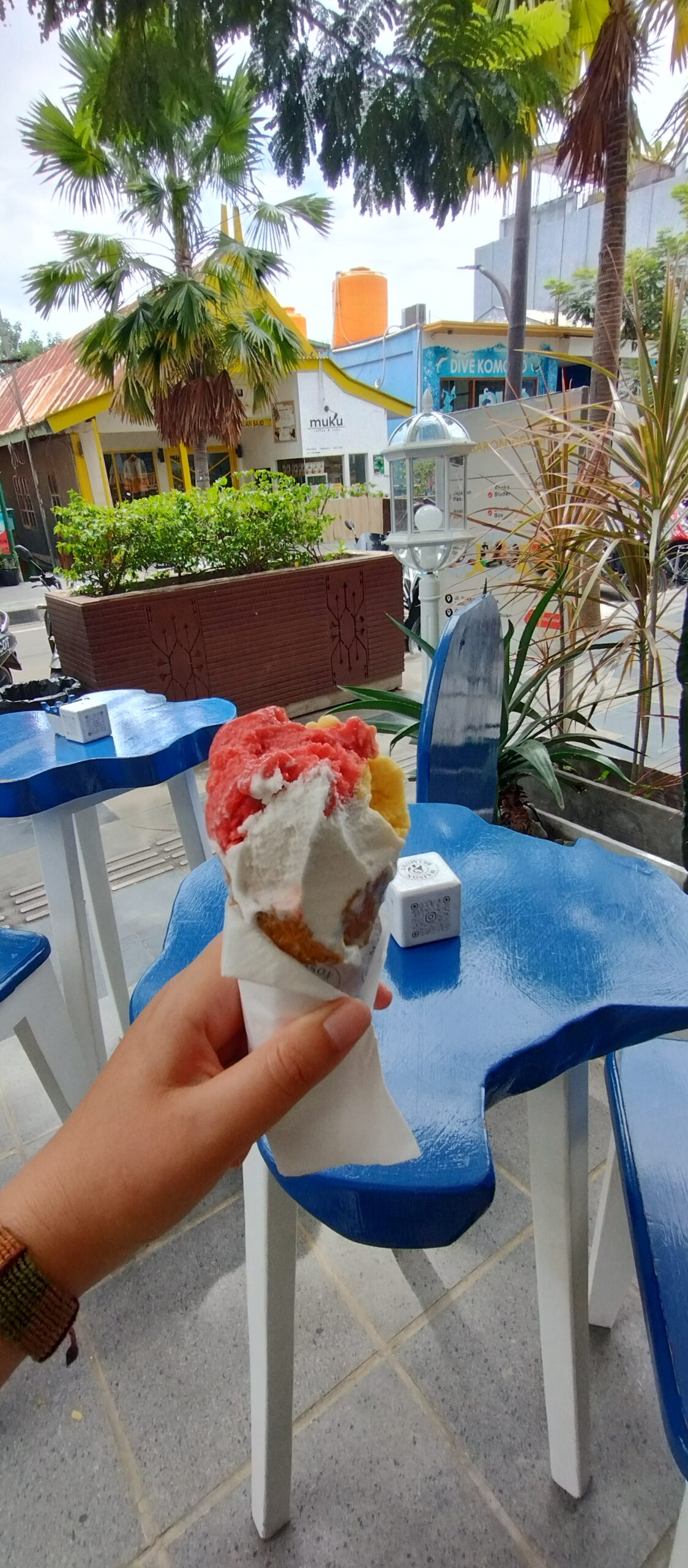 Holding a sorbet cone from Maison Belmont beside the pool