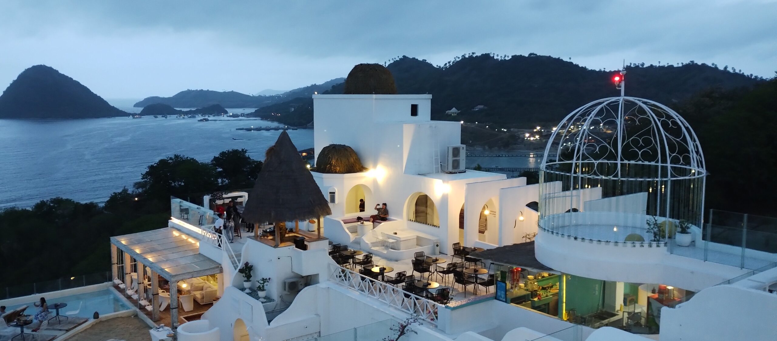 Labuan Bajo at dusk, white buildings on the hillside above the bay