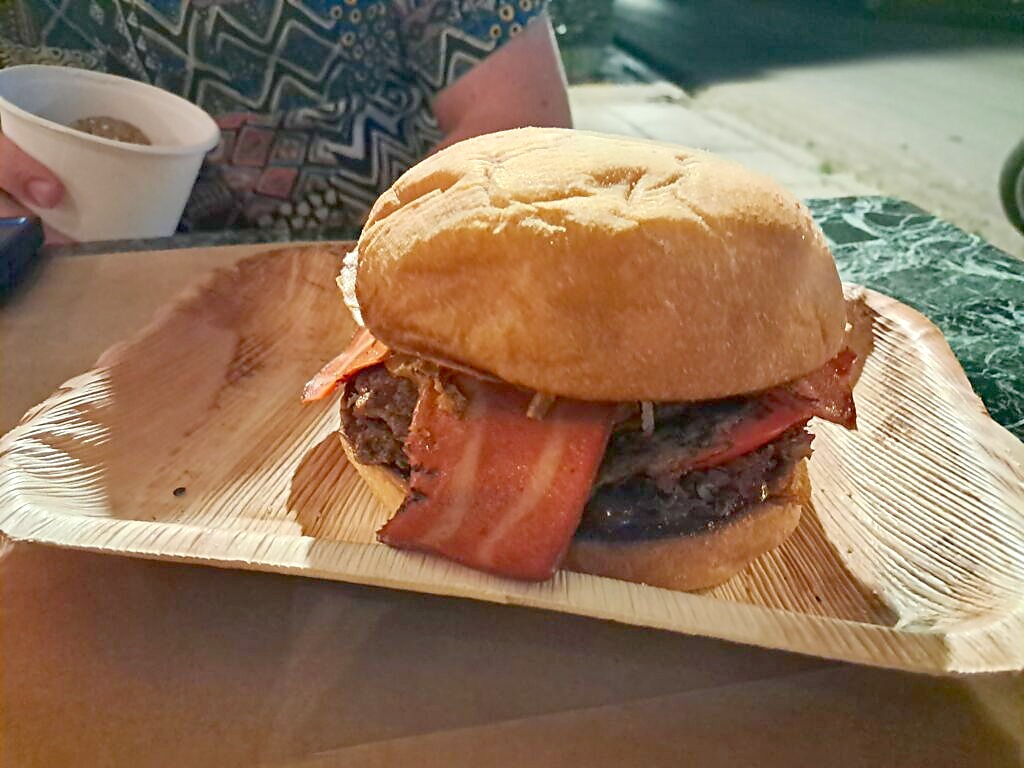 A large vegan burger and chips at a restaurant