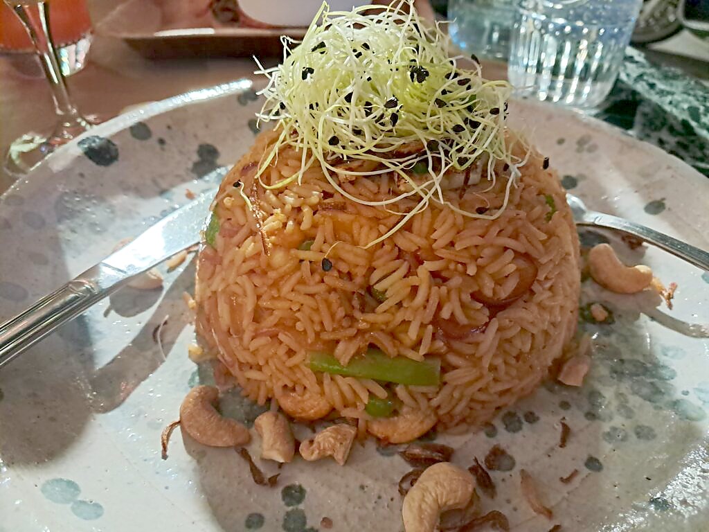 A plate of vegan spiced rice with beansprouts