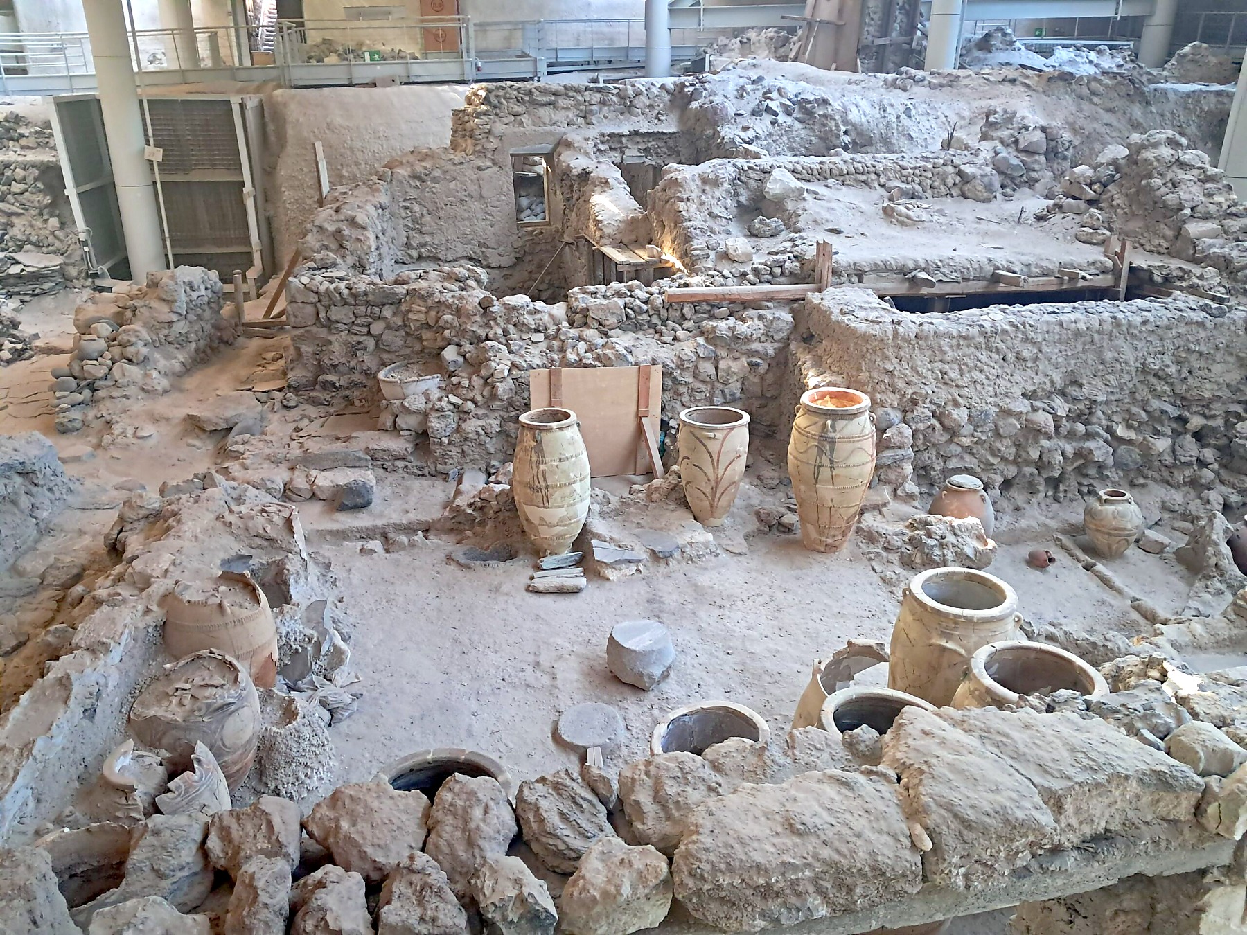 Ancient pottery and ruins inside the Akrotiri archaeological site Santorini