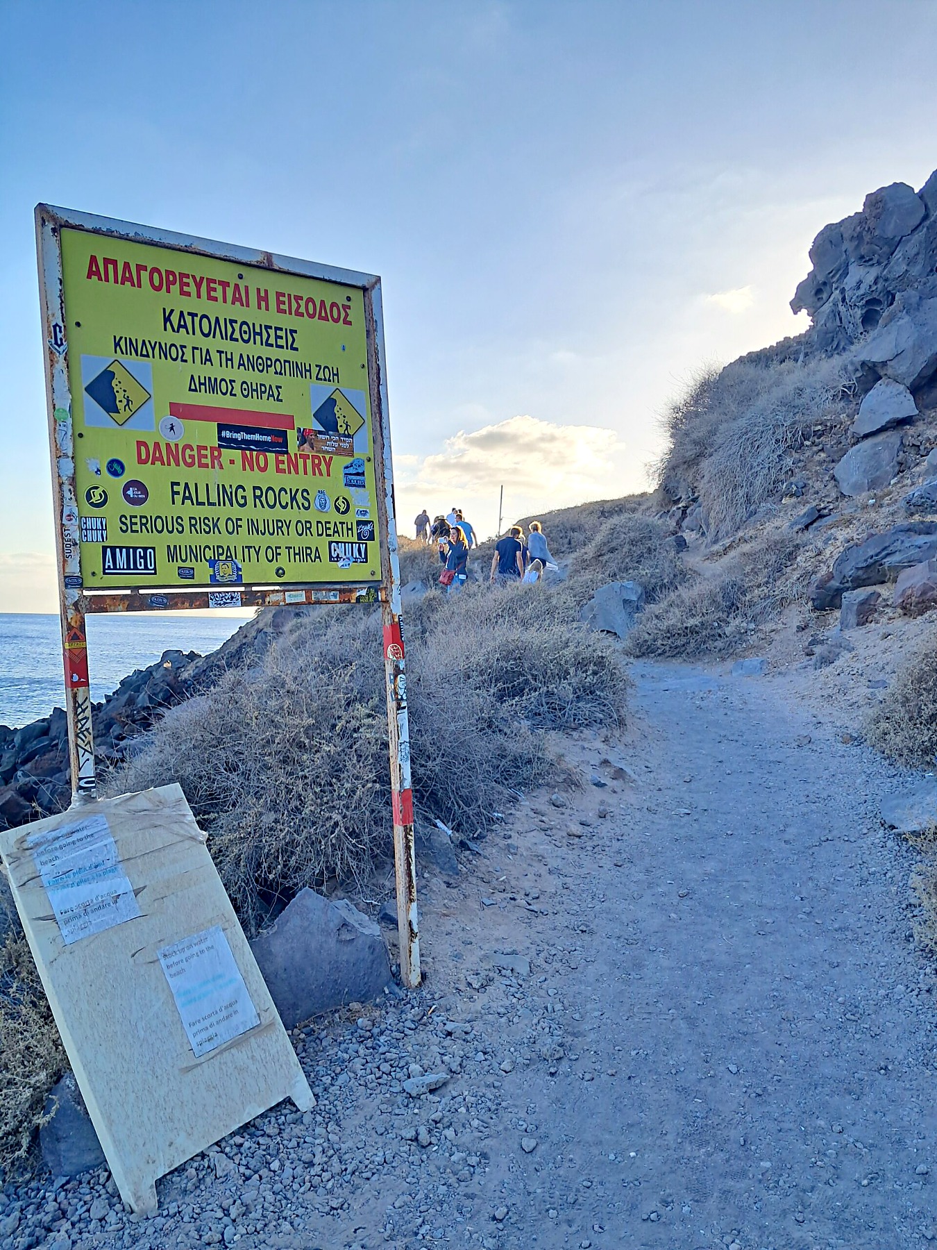 Falling rocks warning sign on the path down to Red Beach, Santorini