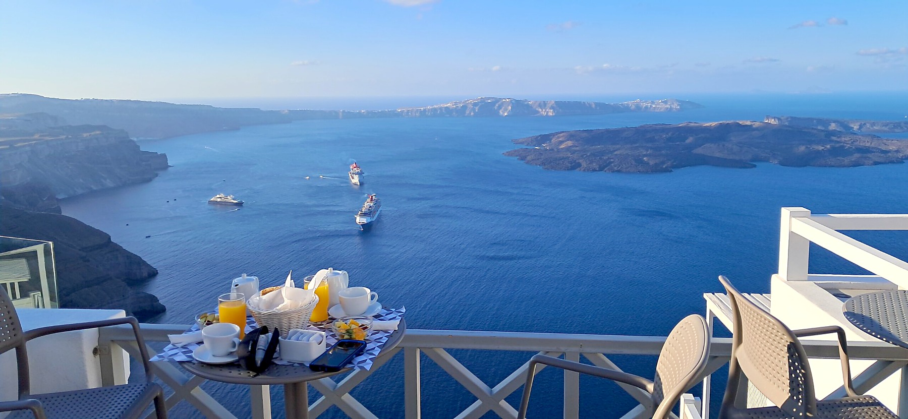 Vegan breakfast on the balcony at Krokus Villas in Imerovigli, overlooking the Santorini caldera