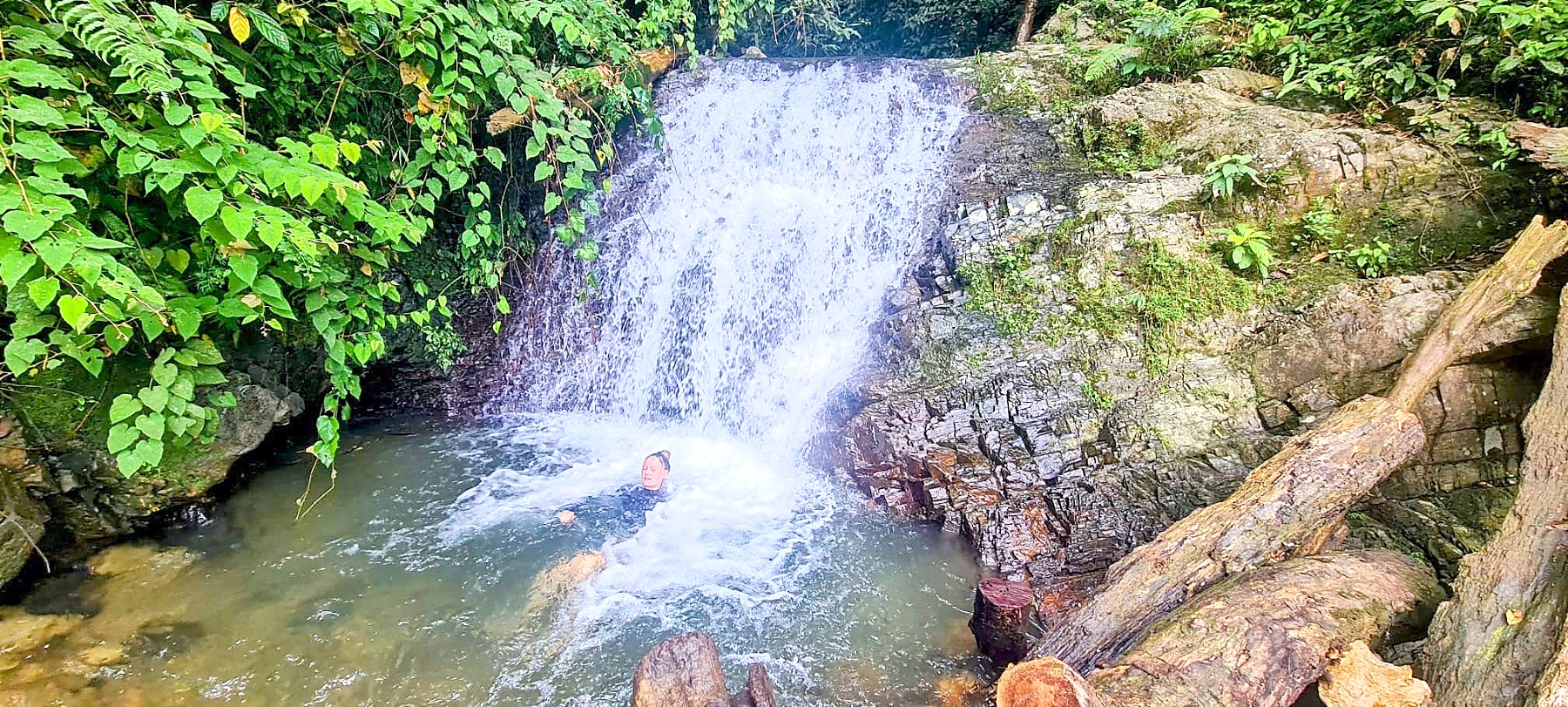 Swimming in the jungle waterfall at the bottom of the trek