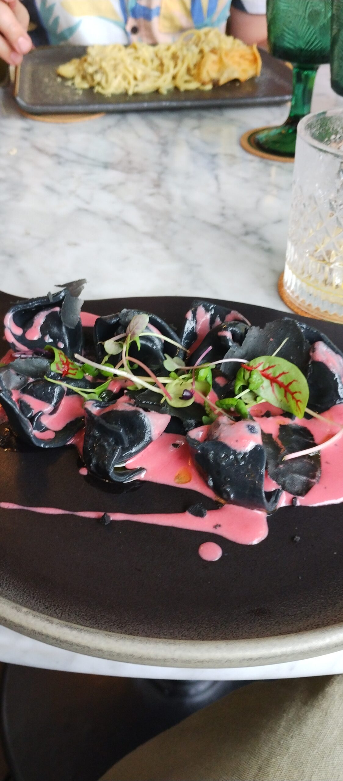 Black tortellini in pink beetroot sauce at Plant B vegan restaurant, Ubud