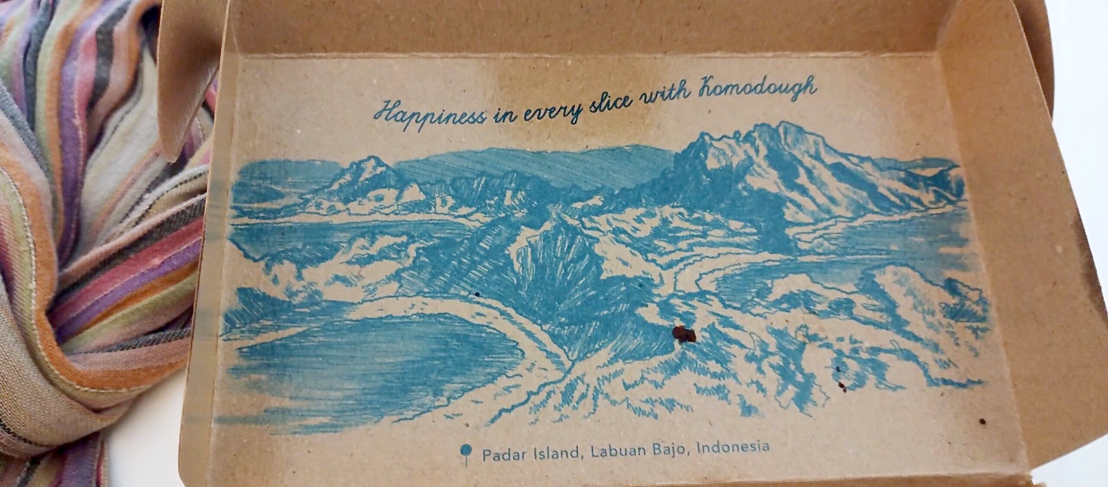 Illustrated Komodough bakery box showing Padar Island