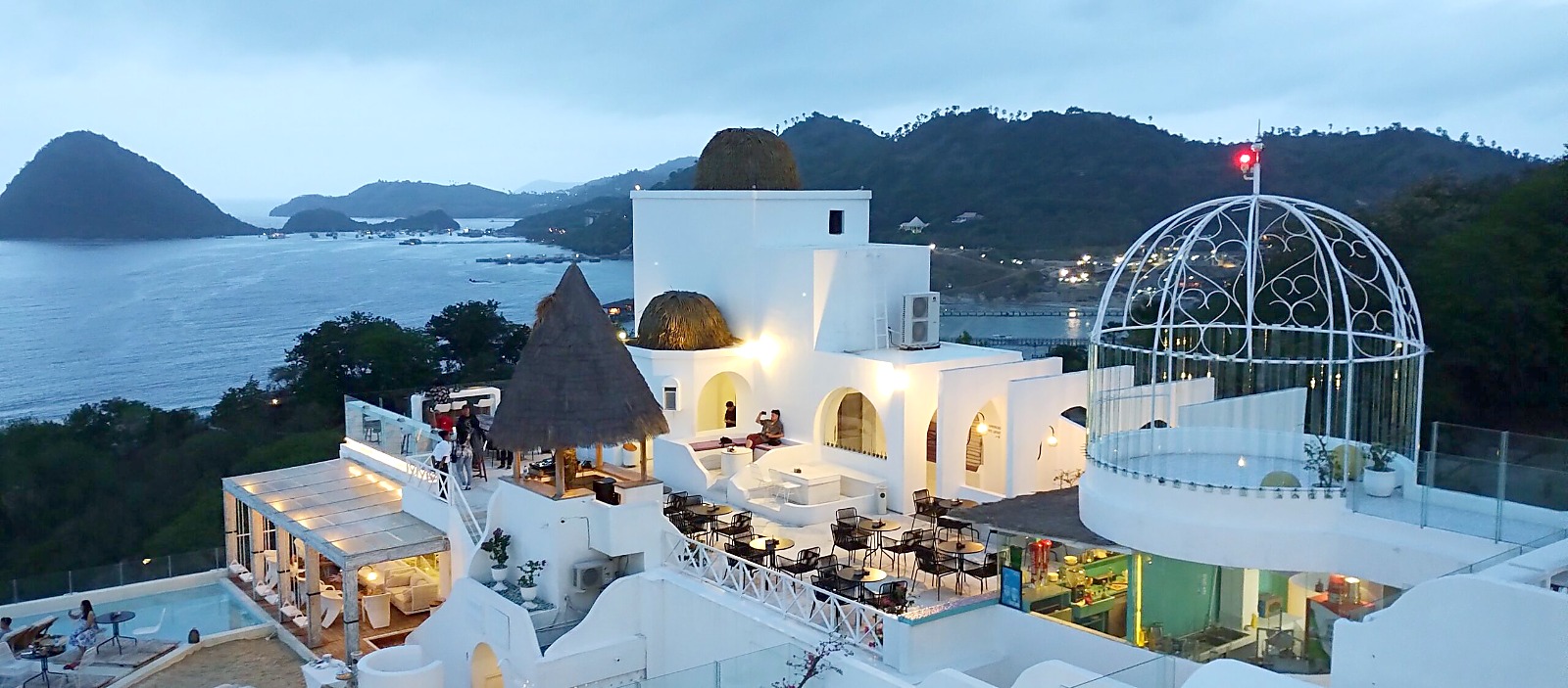 Labuan Bajo at dusk, white buildings on the hillside above the bay