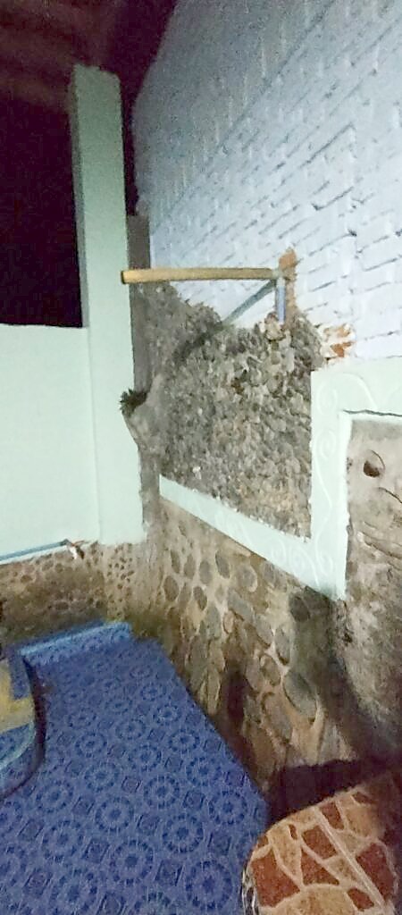 Outdoor shower area at Green Hill guesthouse, Bukit Lawang, with a view over the Bohorok River and jungle beyond